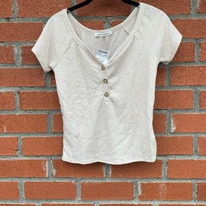 Cream colored crop T-shirt with brown buttons